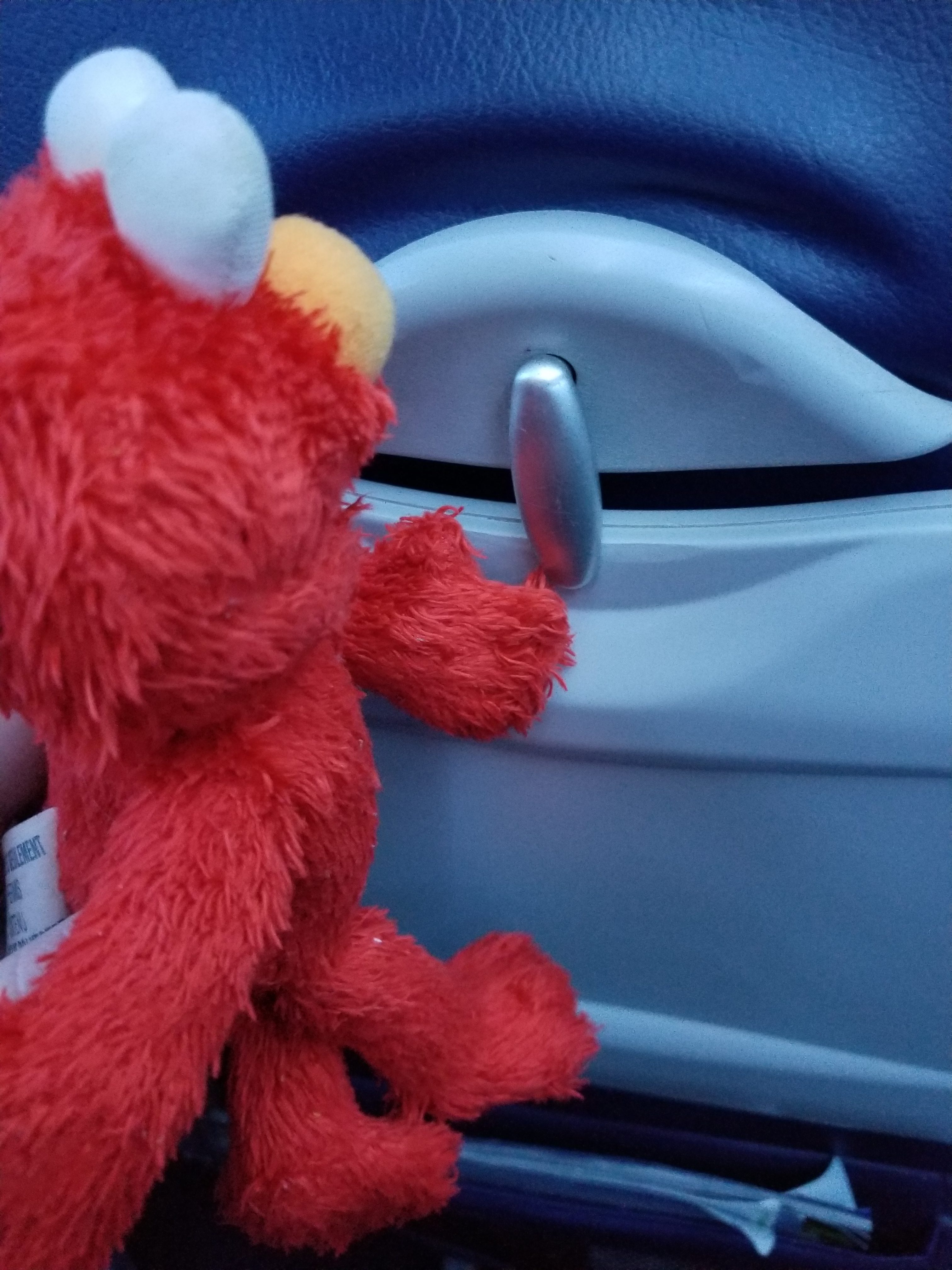 Elmo Stows his Tray Table for Landing