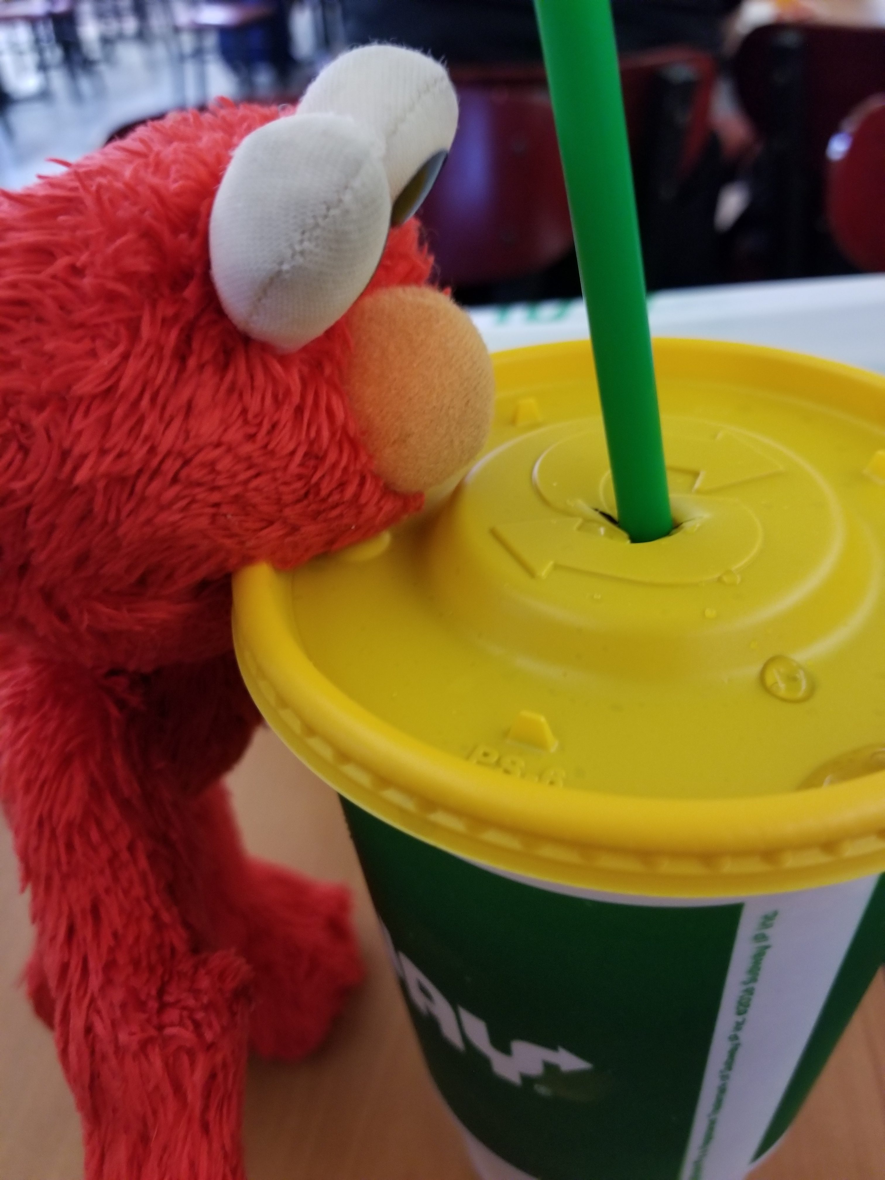 Elmo is so hungry he tries to eat the drink! Silly Elmo.